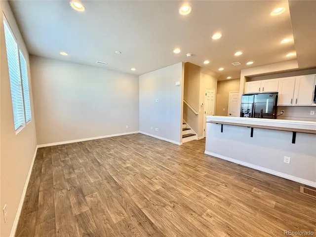 a view of kitchen with cabinets and wooden floor
