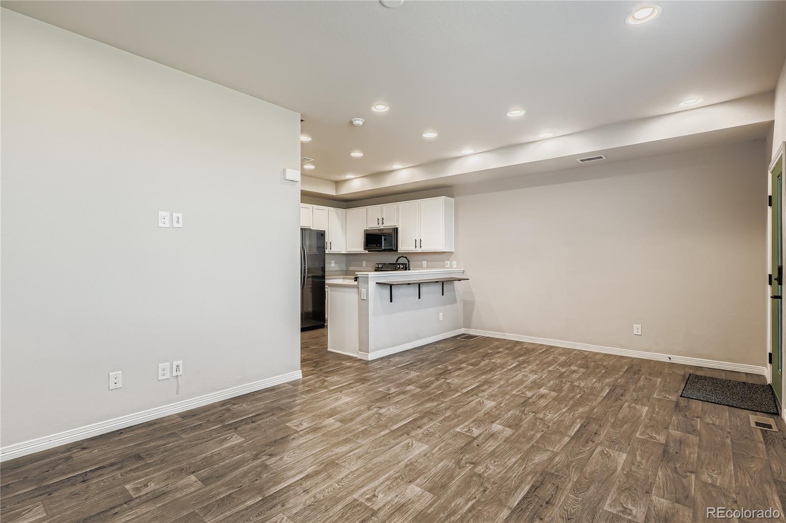 4767 Memphis Street Denver, CO 80239 - Photo 6 of 17 a view of kitchen with granite countertop cabinets and white appliances