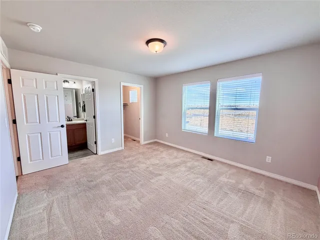 an empty room with furniture and a window