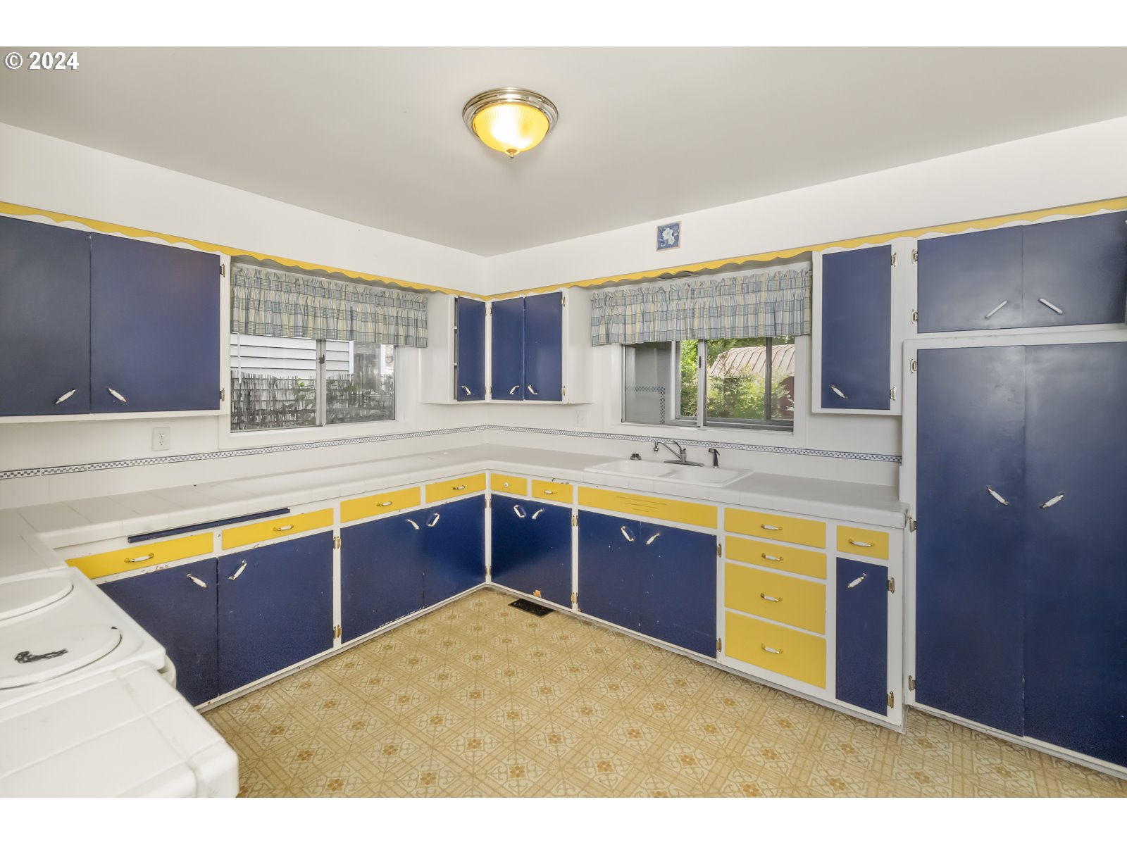 4417 Southeast 65th Avenue Portland, OR 97206 - Photo 12 of 38 a kitchen with stainless steel appliances granite countertop a sink a stove a counter space and cabinets