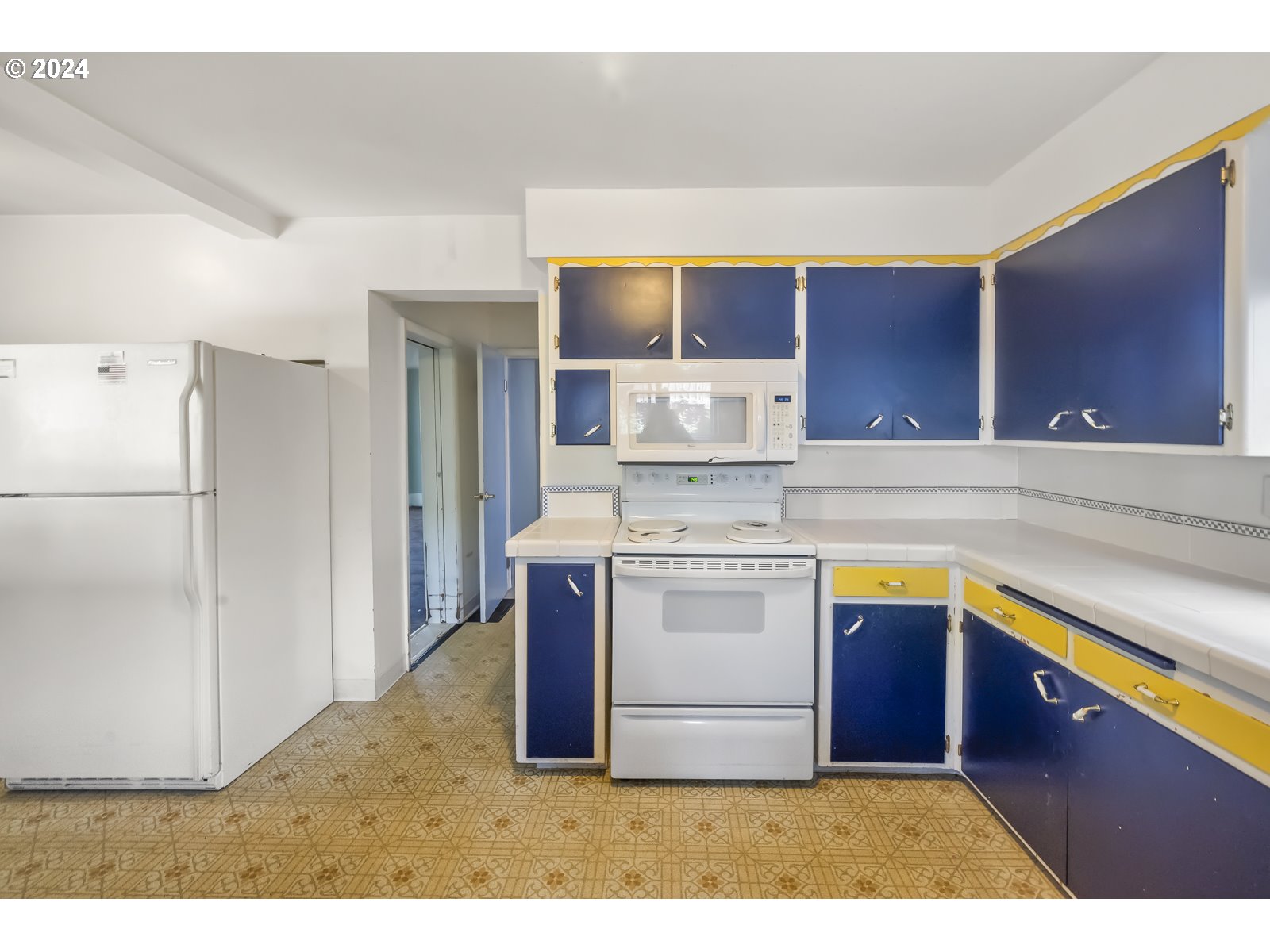 4417 Southeast 65th Avenue Portland, OR 97206 - Photo 16 of 38 a kitchen with stainless steel appliances granite countertop a refrigerator a stove and a sink with wooden cabinets