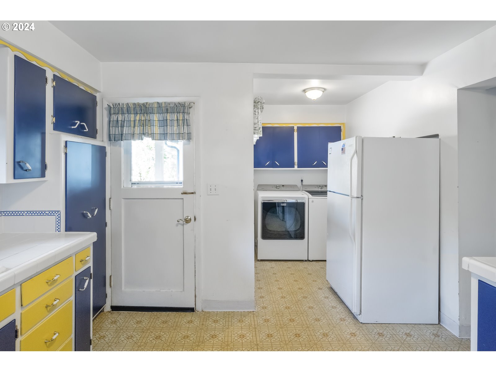 4417 Southeast 65th Avenue Portland, OR 97206 - Photo 17 of 38 a kitchen with stainless steel appliances a refrigerator sink and cabinets