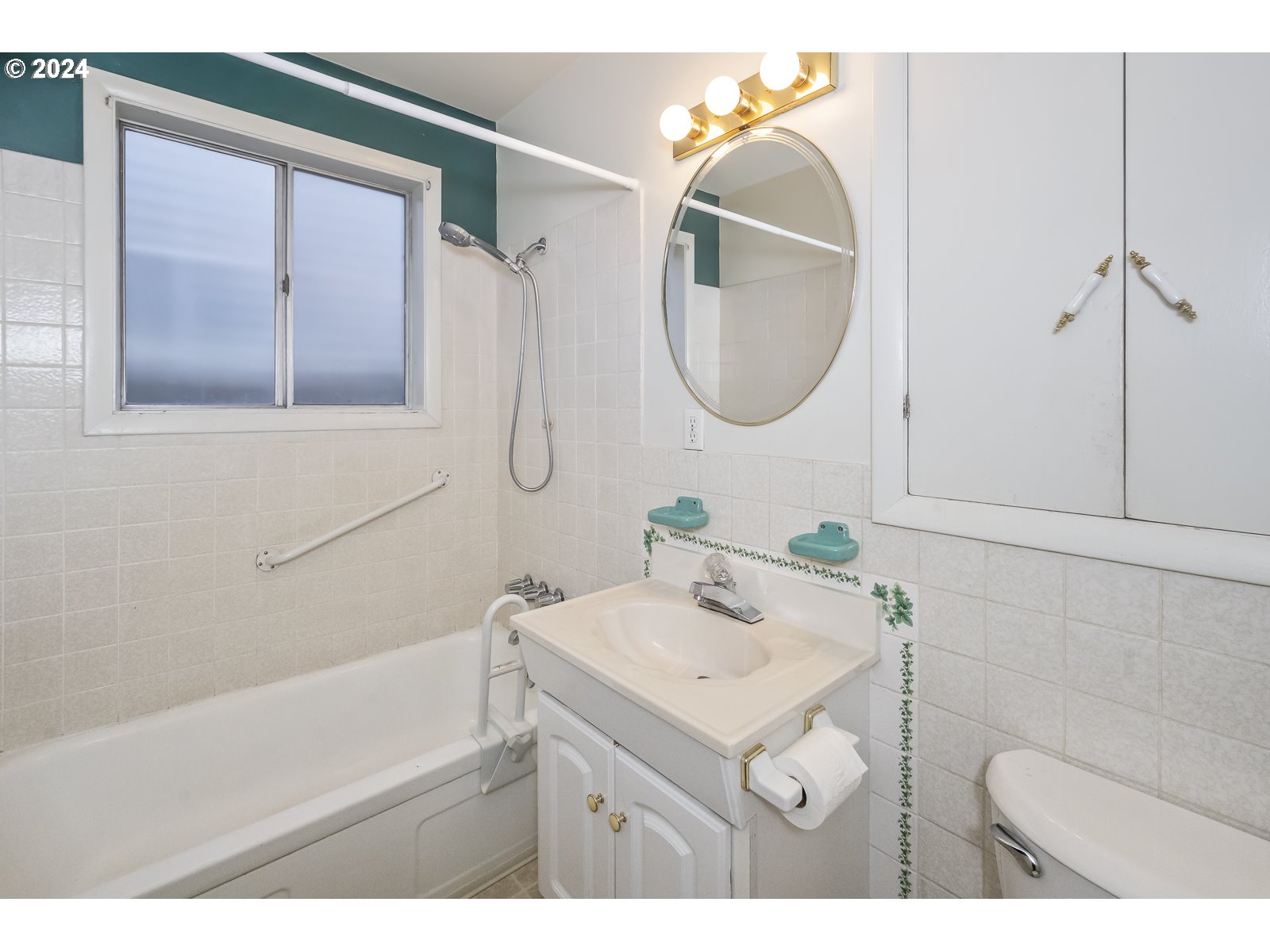 4417 Southeast 65th Avenue Portland, OR 97206 - Photo 20 of 38 a bathroom with a sink mirror and vanity