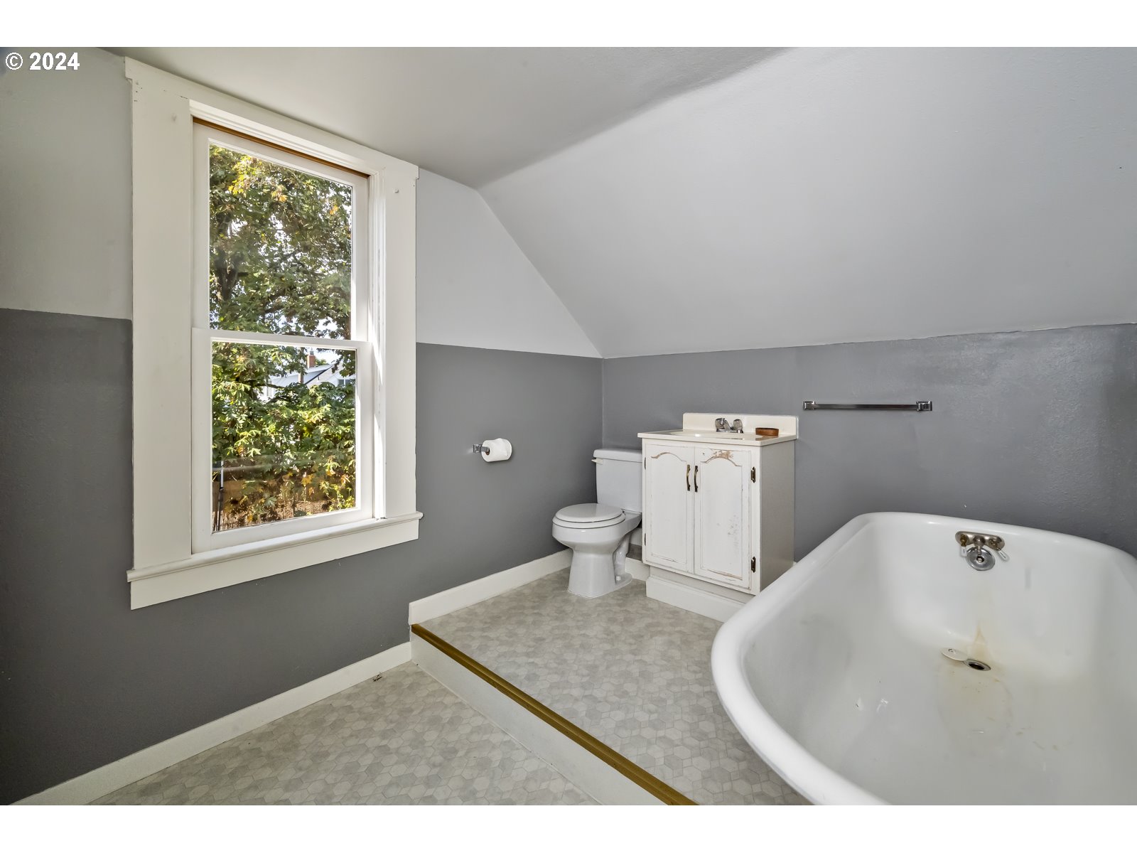 4417 Southeast 65th Avenue Portland, OR 97206 - Photo 27 of 38 a bathroom with a toilet sink and mirror next to a window