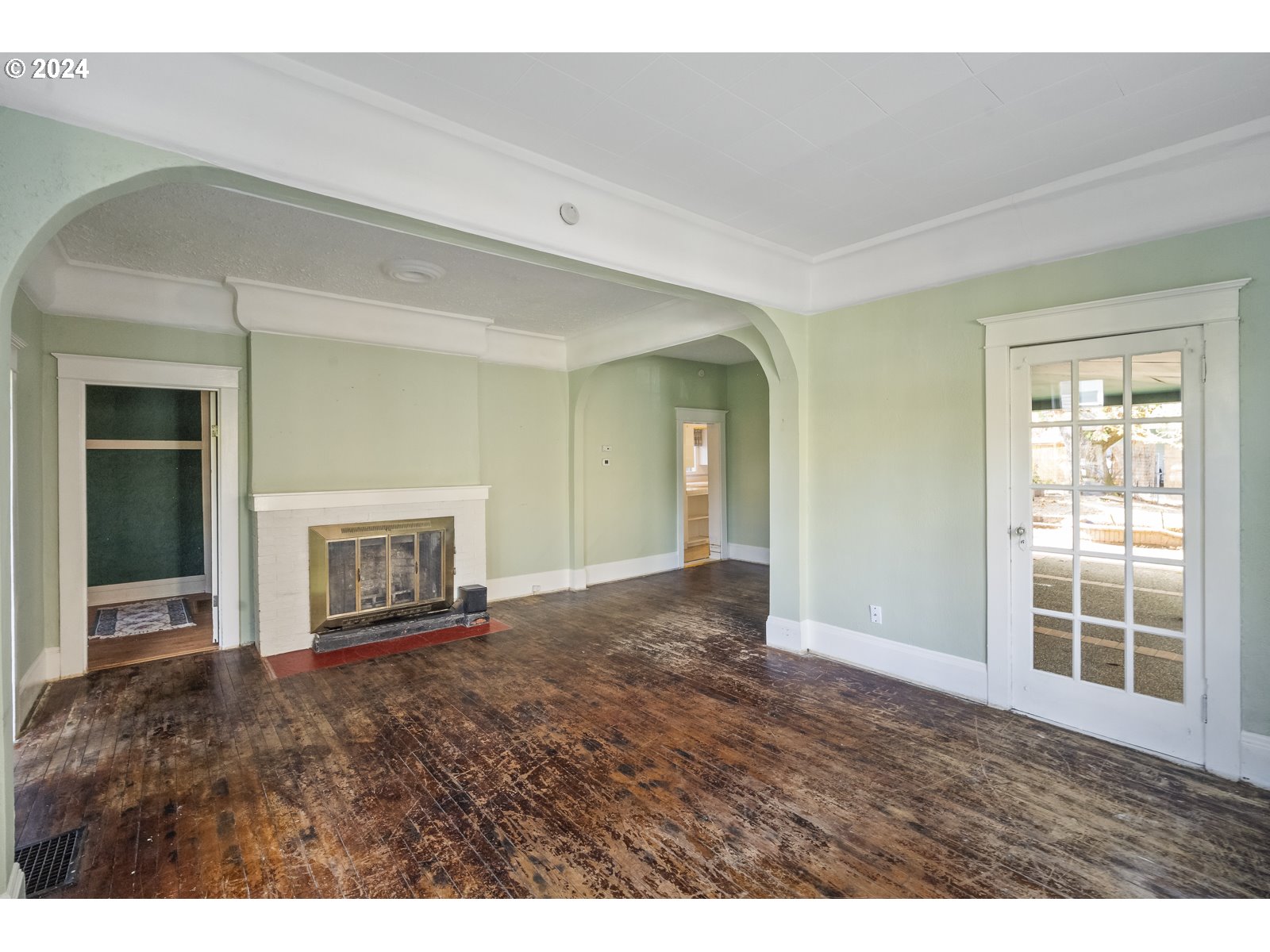 4417 Southeast 65th Avenue Portland, OR 97206 - Photo 4 of 38 a view of an empty room with window and fire place