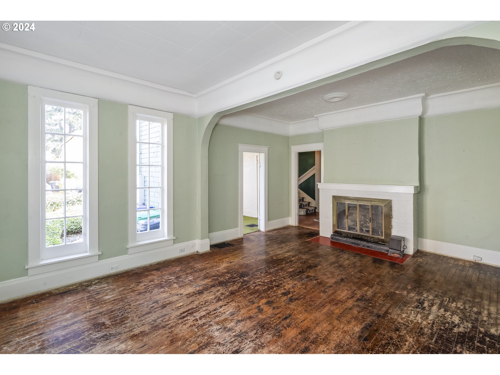 4417 Southeast 65th Avenue Portland, OR 97206 - Photo 6 of 38 a view of an empty room with window and fire place