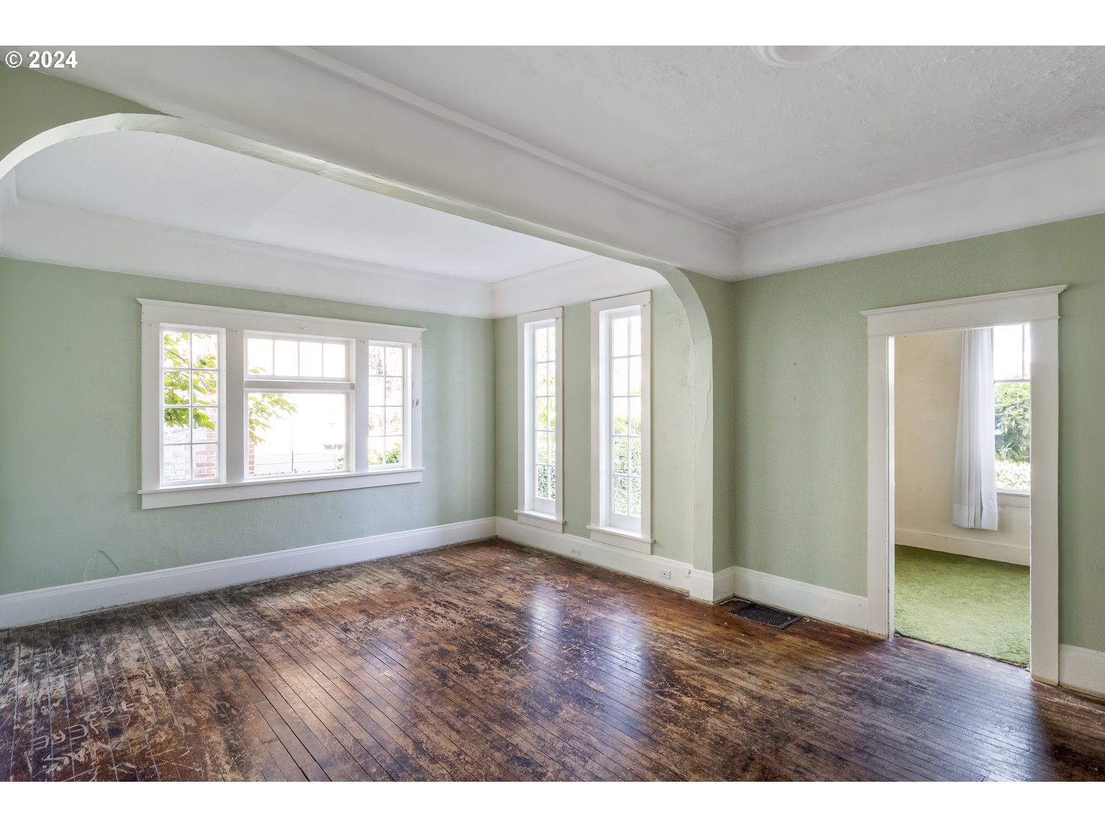 4417 Southeast 65th Avenue Portland, OR 97206 - Photo 7 of 38 a view of an empty room with wooden floor and a window