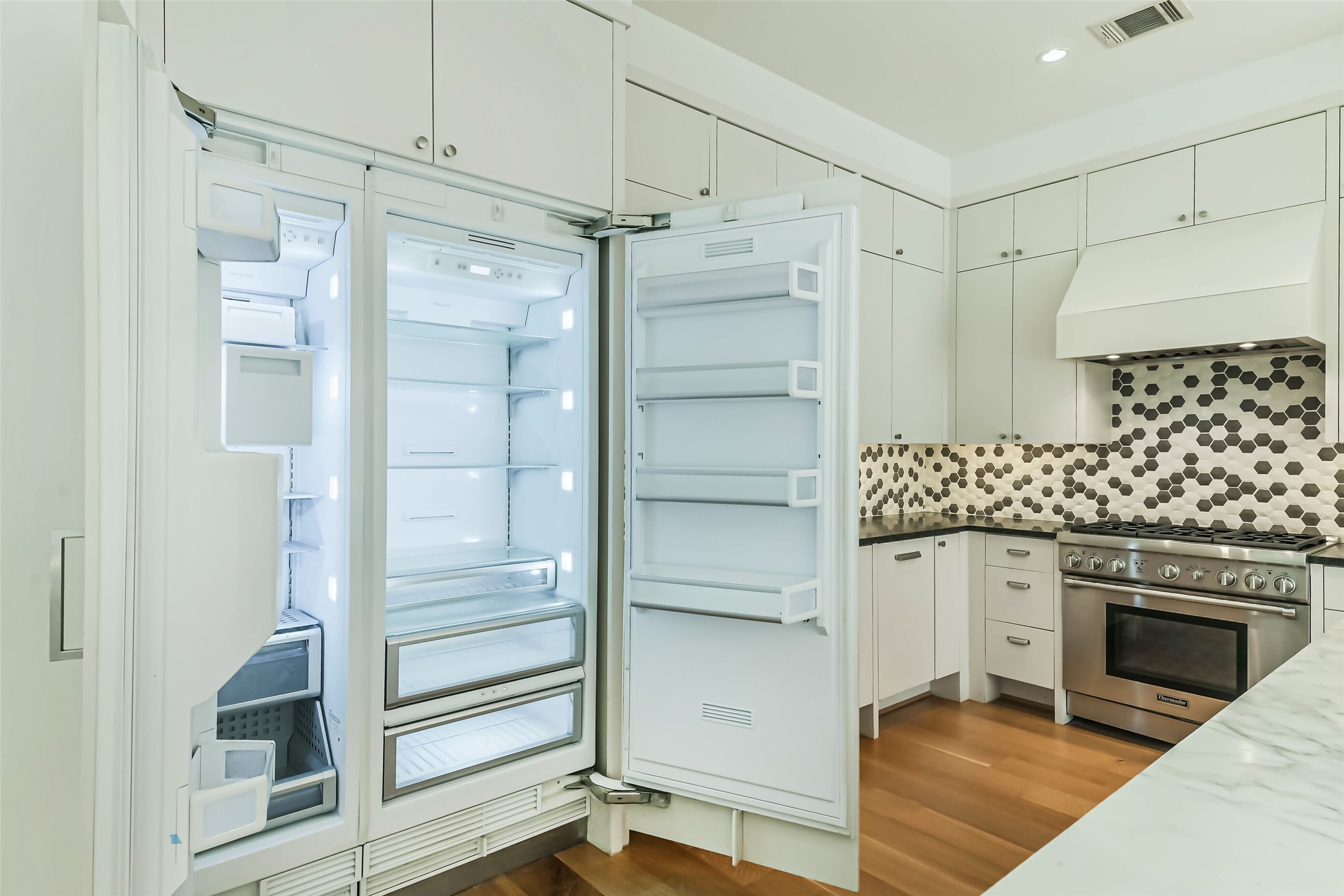 815 Alexander Street Houston, TX 77007 - Photo 17 of 49 Built-in refrigerator seamlessly integrated into custom cabinetry.