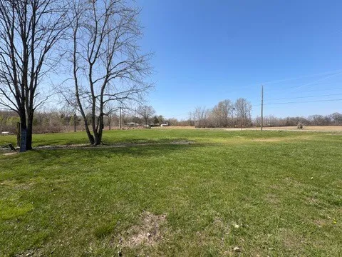 a view of a field with trees around