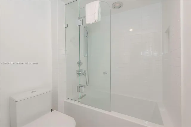 a bathroom with a shower and a toilet