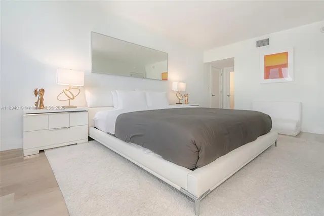 a living room with a bed and dresser