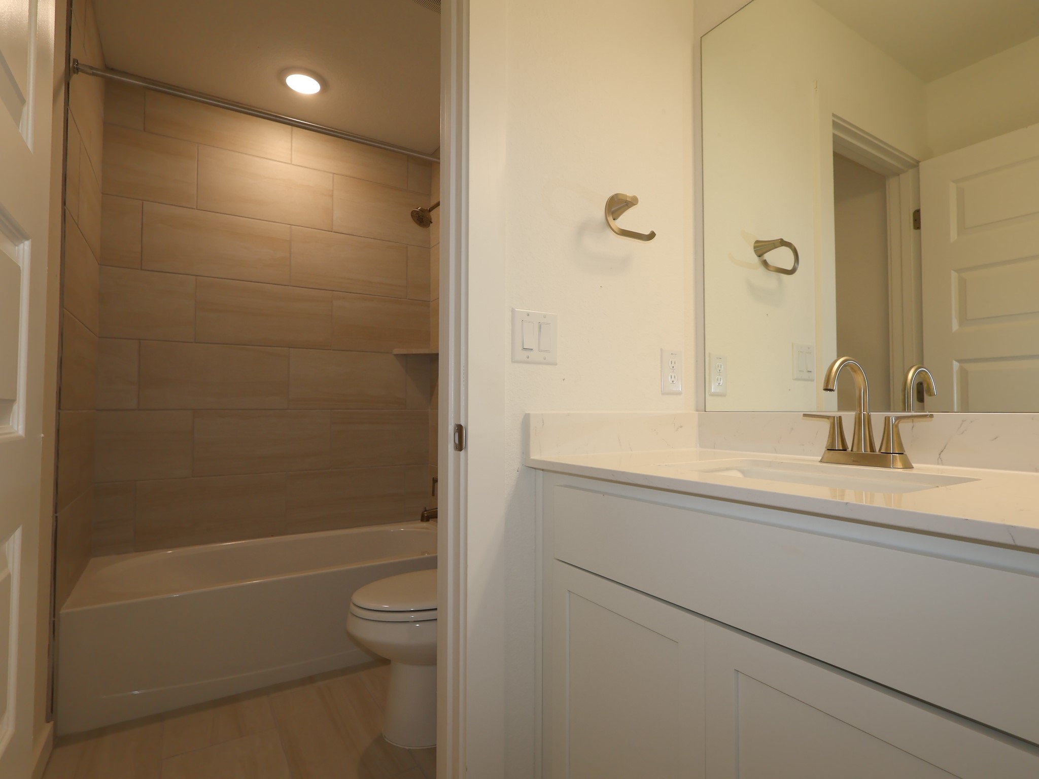 3977 Waco Way Leander, TX 78641 - Photo 15 of 23 a bathroom with a granite countertop sink a toilet and shower