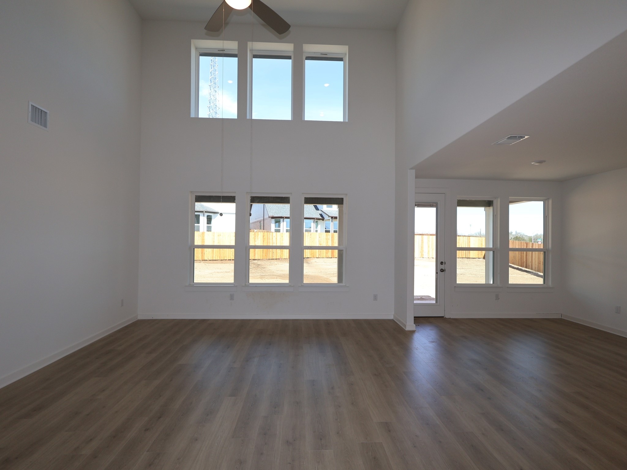 3977 Waco Way Leander, TX 78641 - Photo 4 of 23 an empty room with wooden floor and windows