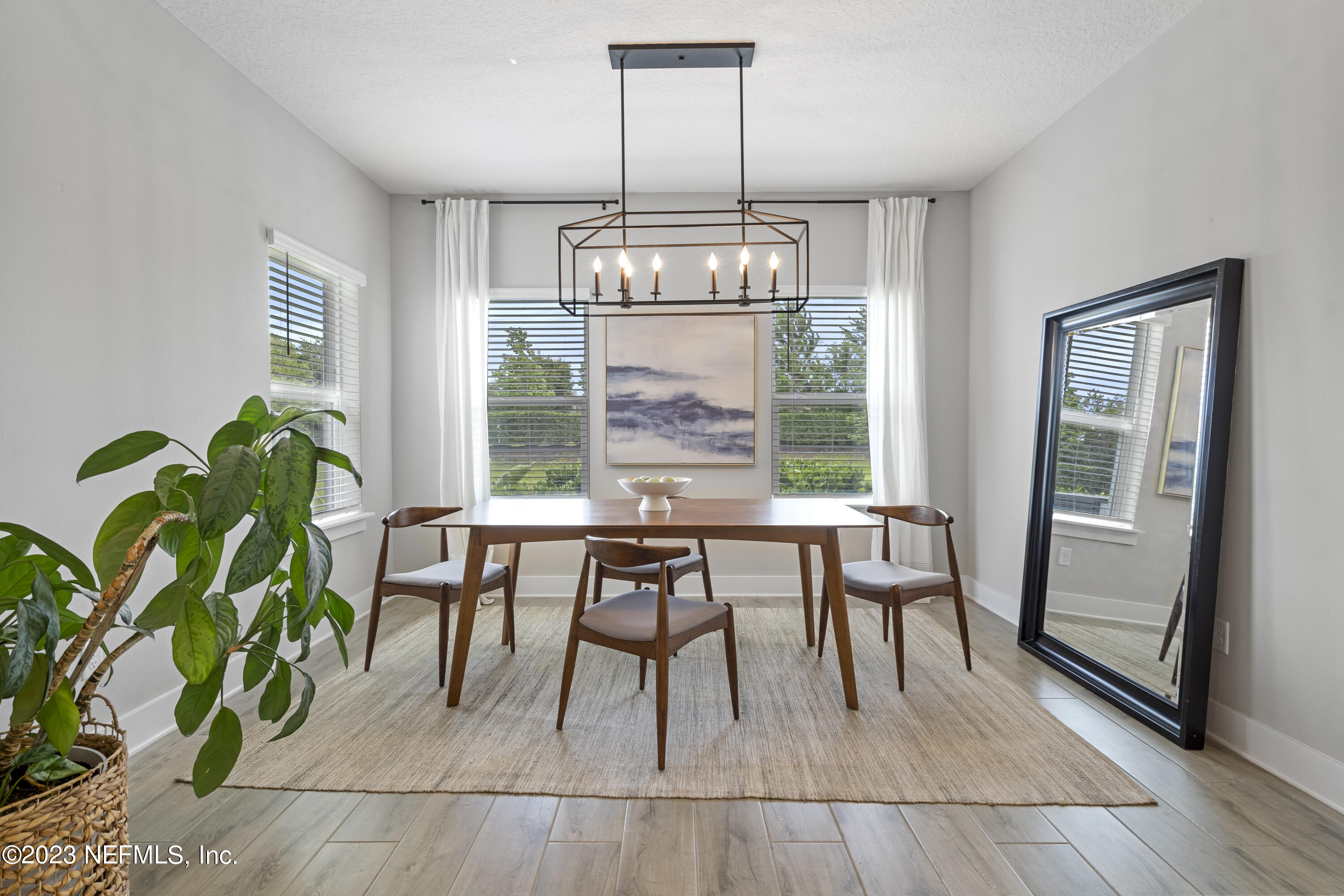36 Strobe Court St. Augustine, FL 32095 - Photo 20 of 47 a dining room with wooden floor a chandelier a glass table and chairs