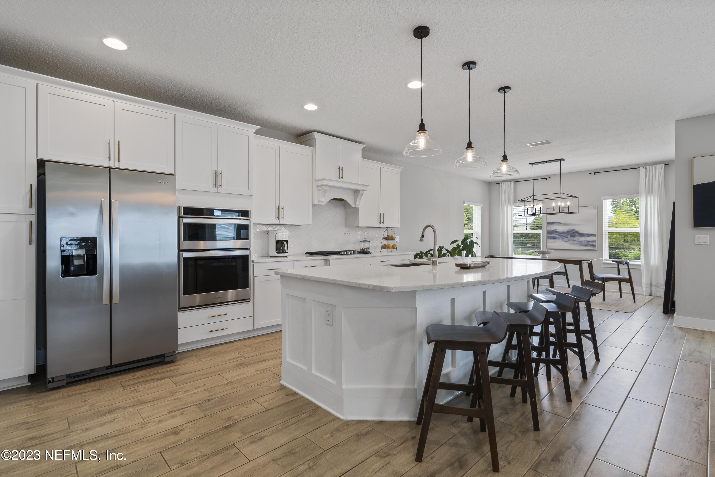 36 Strobe Court St. Augustine, FL 32095 - Photo 2 of 47 a kitchen with stainless steel appliances kitchen island granite countertop a dining table chairs refrigerator and sink
