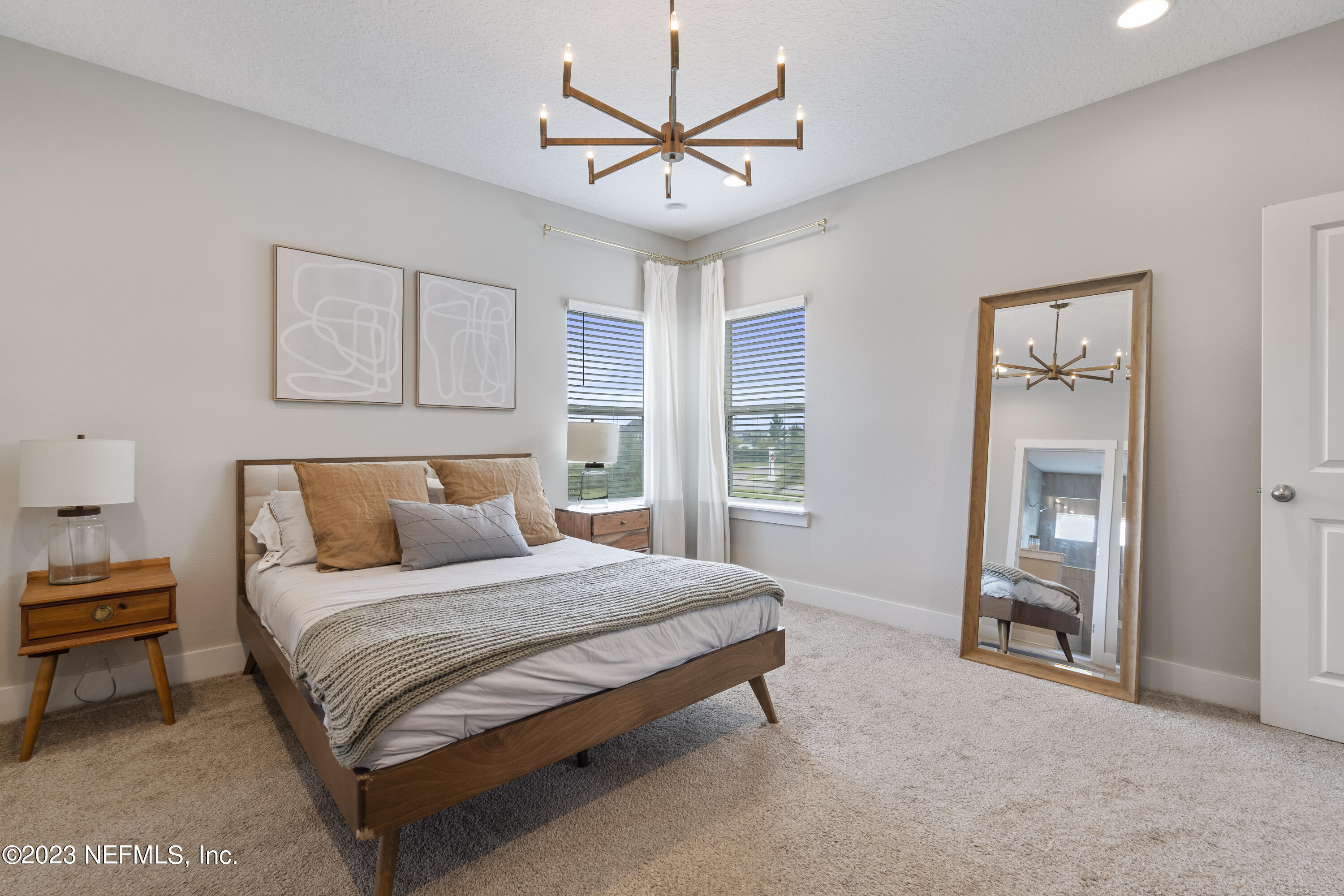 36 Strobe Court St. Augustine, FL 32095 - Photo 25 of 47 a bedroom with a bed and a chandelier