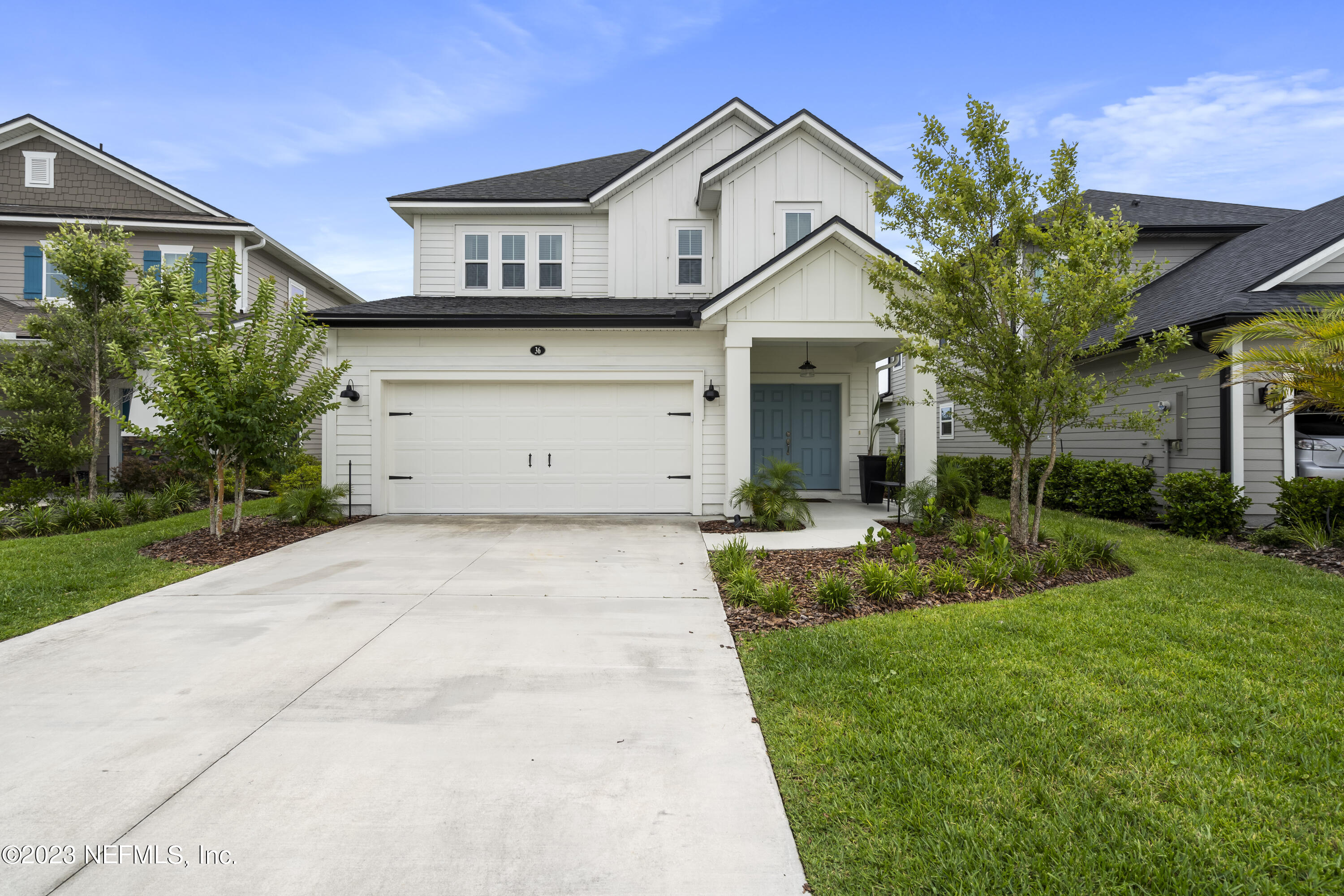 36 Strobe Court St. Augustine, FL 32095 - Photo 7 of 47 a view of a white house with a small yard plants and a large tree
