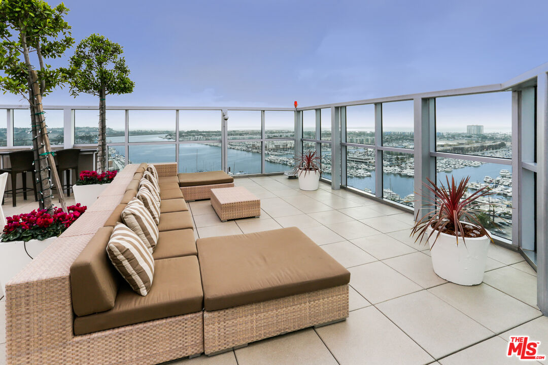 13700 Marina Pointe Drive, Unit PH 1903 Marina del Rey, CA 90292 - Photo 17 of 35 a living room with furniture and a floor to ceiling window