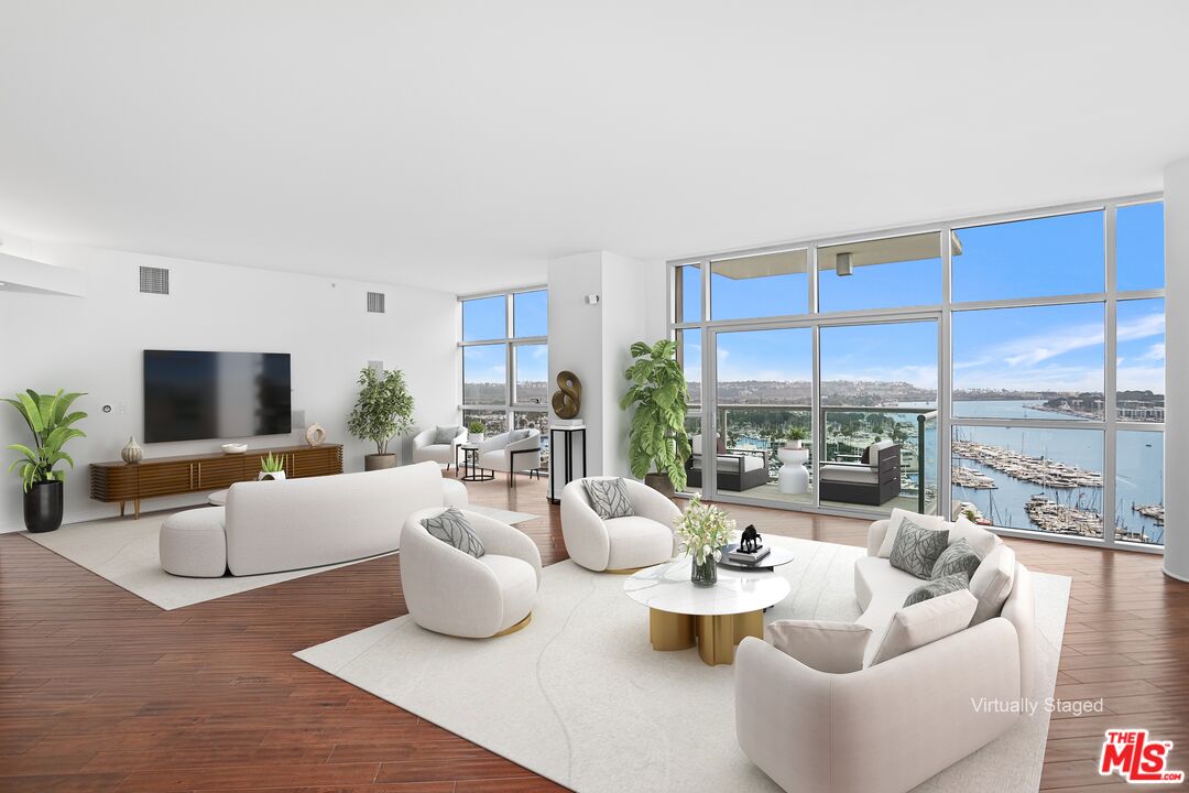 13700 Marina Pointe Drive, Unit PH 1903 Marina del Rey, CA 90292 - Photo 26 of 35 a living room with furniture and a large window