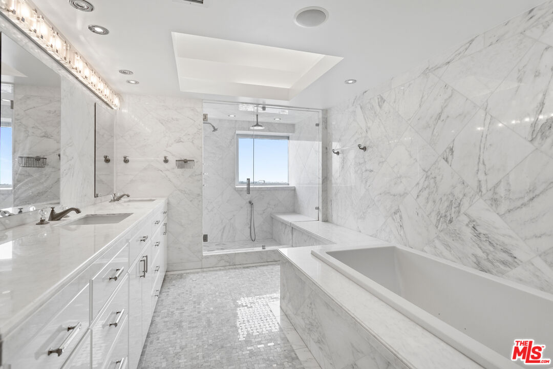 13700 Marina Pointe Drive, Unit PH 1903 Marina del Rey, CA 90292 - Photo 29 of 35 a spacious bathroom with a tub sink shower and mirror