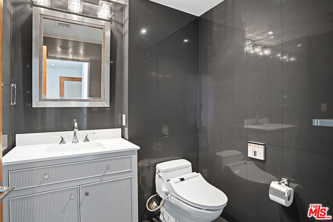 13700 Marina Pointe Drive, Unit PH 1903 Marina del Rey, CA 90292 - Photo 35 of 35 a bathroom with a toilet a sink and mirror