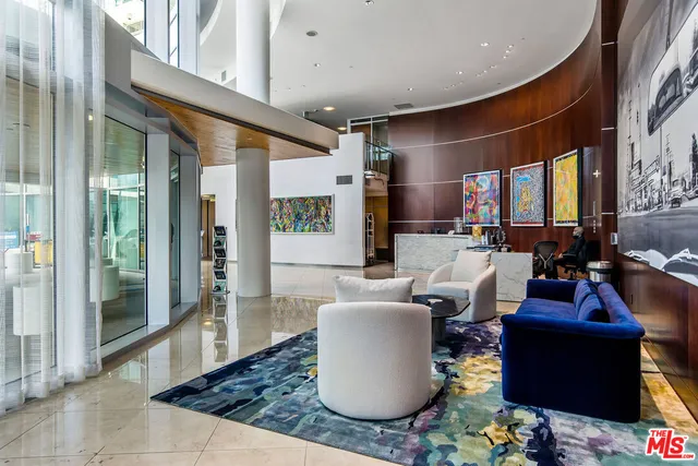 a living room with furniture a rug and a large window