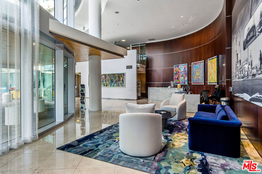 13700 Marina Pointe Drive, Unit PH 1903 Marina del Rey, CA 90292 - Photo 4 of 35 a living room with furniture a rug and a large window