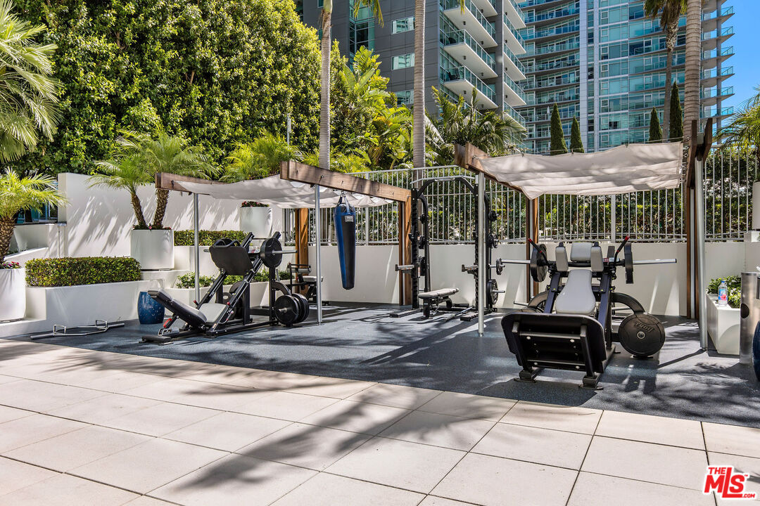 13700 Marina Pointe Drive, Unit PH 1903 Marina del Rey, CA 90292 - Photo 9 of 35 a view of a patio with table and chairs under an umbrella