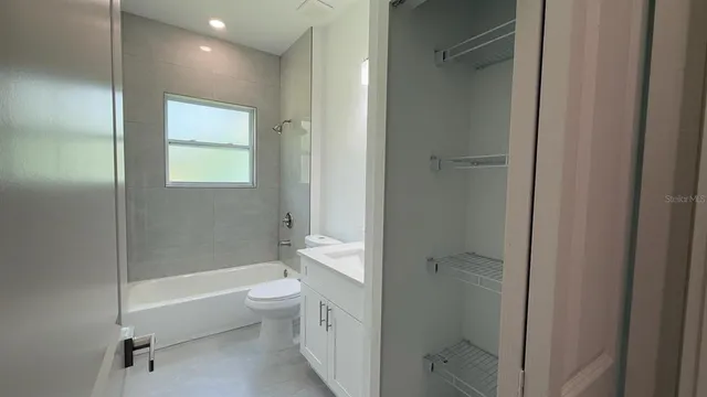 a bathroom with a shower a toilet and a shower