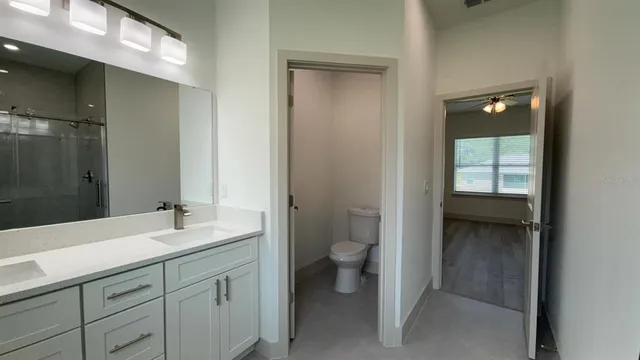 a bathroom with a toilet sink and mirror