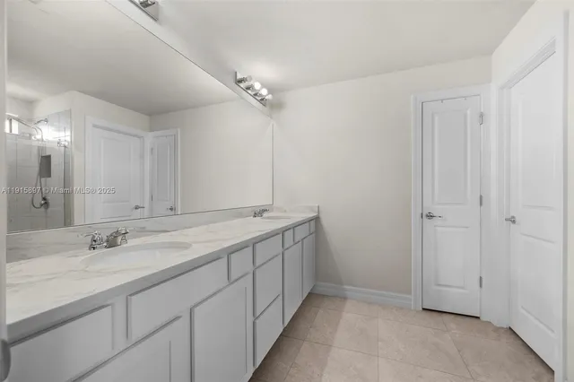 a bathroom with a double vanity sink and a mirror