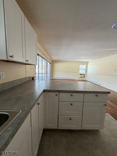 113 D North Shore Point Montague, NJ 07827 - Photo 4 of 18 a kitchen with granite countertop white cabinets and a sink