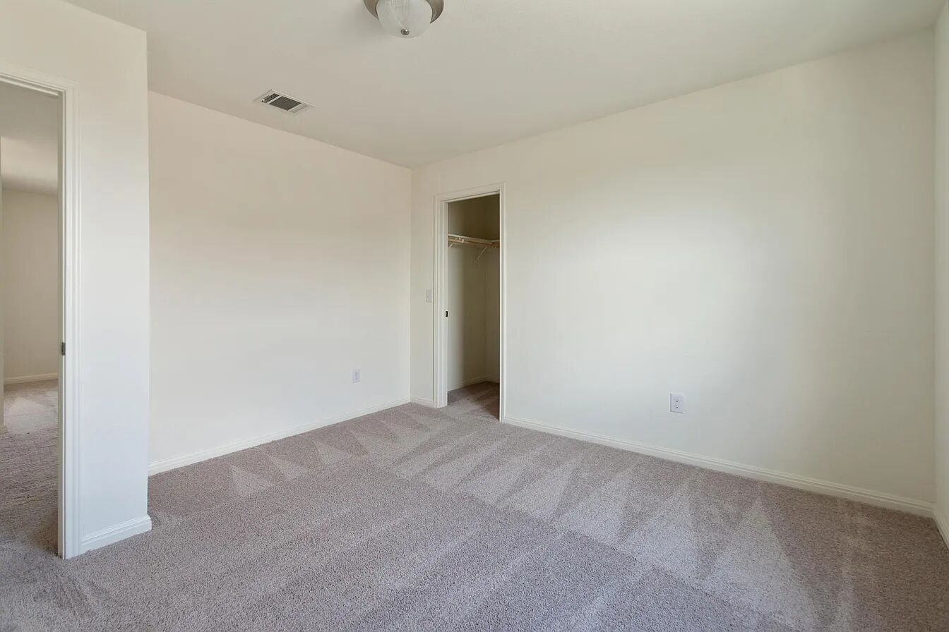 101 Aoudad Road Hutto, TX 78634 - Photo 32 of 39 A spacious, light-filled bedroom with plush carpeting, ready for personalization.