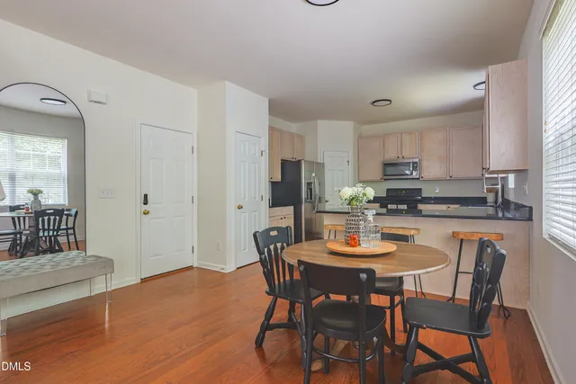 a kitchen with white cabinets and sink