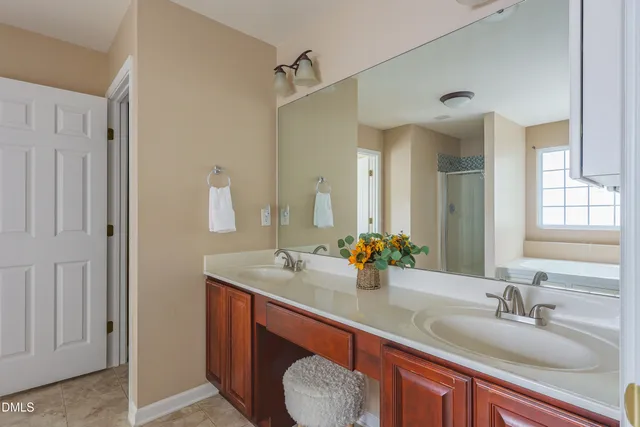 a bathroom with a tub a sink and a window