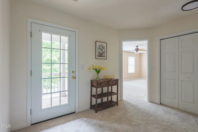 a living room with furniture a window and dresser