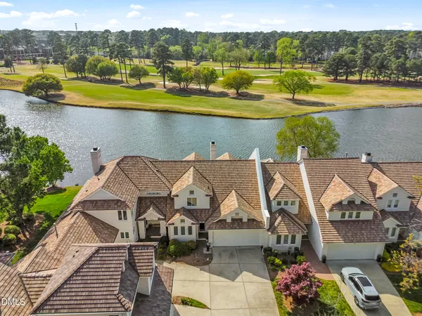 an aerial view of a house with a lake view
