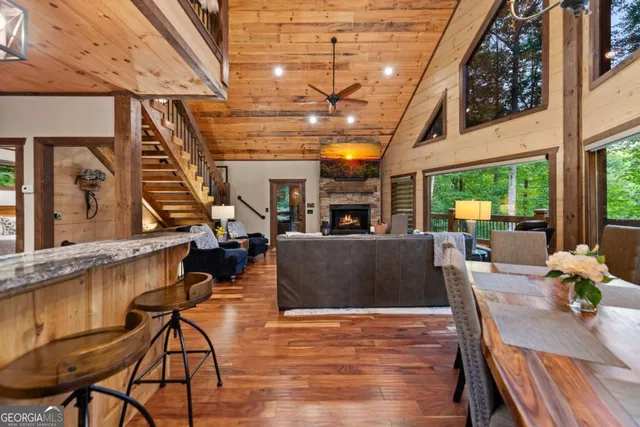 a kitchen with stainless steel appliances granite countertop table chairs refrigerator and sink