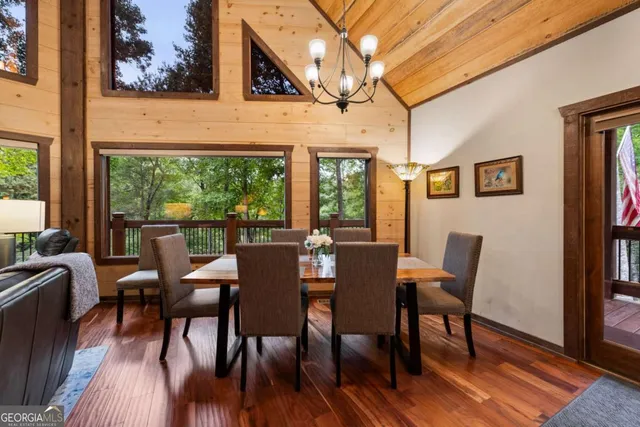 a living room with patio furniture and a grill