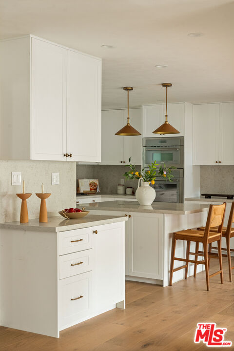 851 Dickson Street Marina del Rey, CA 90292 - Photo 14 of 39 a kitchen with kitchen island granite countertop a table and chairs in it