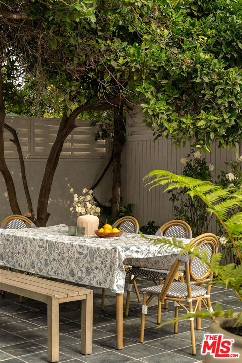 851 Dickson Street Marina del Rey, CA 90292 - Photo 21 of 39 a view of a patio with table and chairs with wooden floor and fence