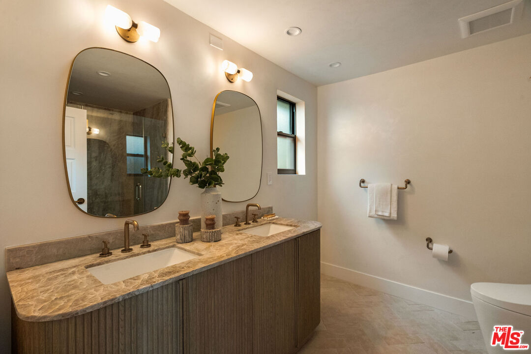 851 Dickson Street Marina del Rey, CA 90292 - Photo 27 of 39 a bathroom with double vanity sinks and a mirror