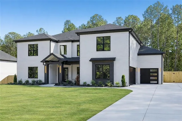 a front view of a house with a garden