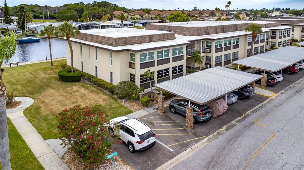 4832 Jasper Drive, Unit 107 New Port Richey, FL 34652 - Photo 20 of 27 an aerial view of a house with a garden space and lake view