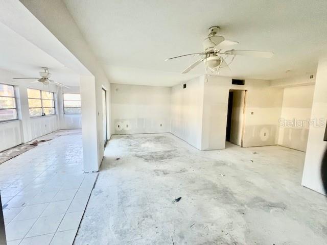 4832 Jasper Drive, Unit 107 New Port Richey, FL 34652 - Photo 5 of 27 a view of a big room with chandelier fan and windows