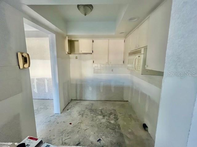 4832 Jasper Drive, Unit 107 New Port Richey, FL 34652 - Photo 7 of 27 a view of kitchen with wooden floor