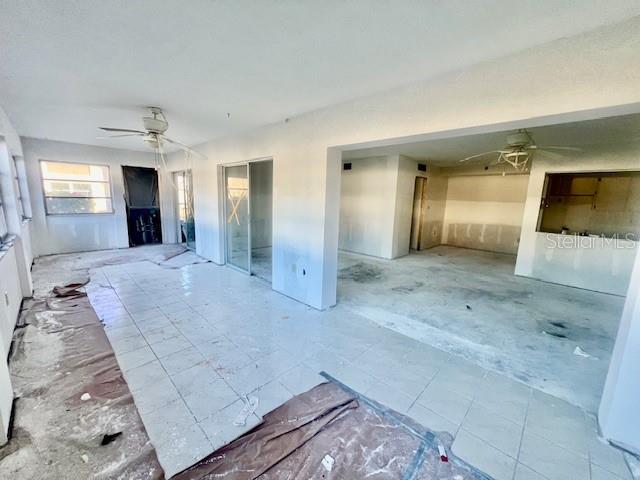 4832 Jasper Drive, Unit 107 New Port Richey, FL 34652 - Photo 9 of 27 a view of a hallway with wooden floor and chandelier