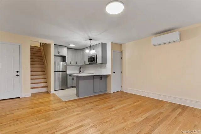 a view of a kitchen with wooden floor