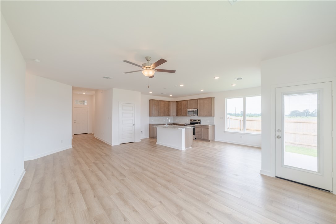 1901 Sebright Drive Bryan, TX 77807 - Photo 5 of 13 a view of an empty room with wooden floor and a window