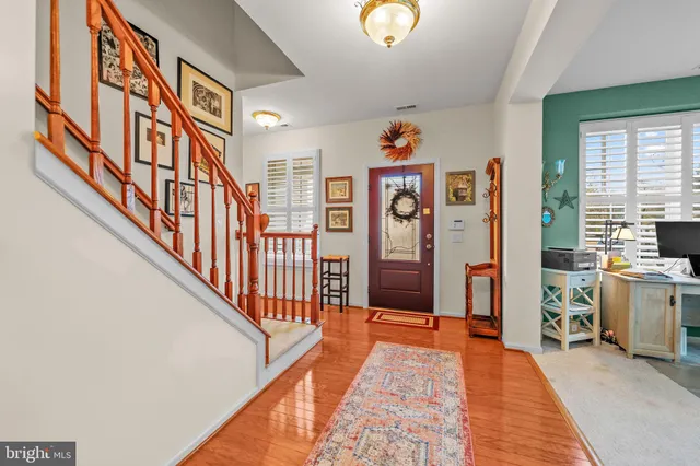 a hallway with a couch and paintings on the walls